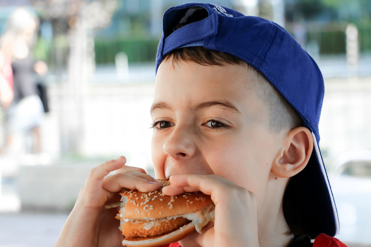 child-eating-a-burger-2021-09-02-23-06-37-utc